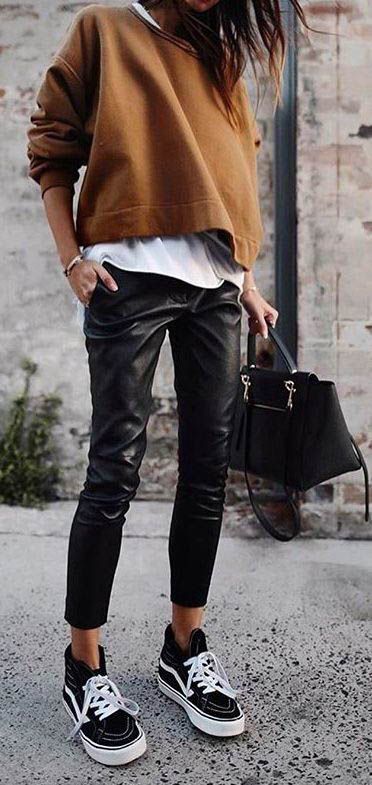 Casual outfit for women. Brown sweater, white t-shirt, black glossy pants and Va...