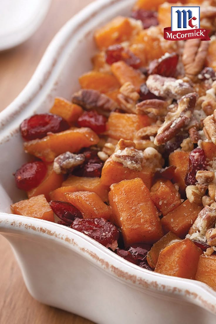 a white bowl filled with sweet potatoes and pecans