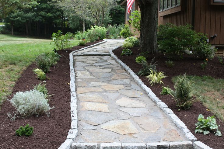 Bordered by granite cobblestone, this natural stone walkway is a