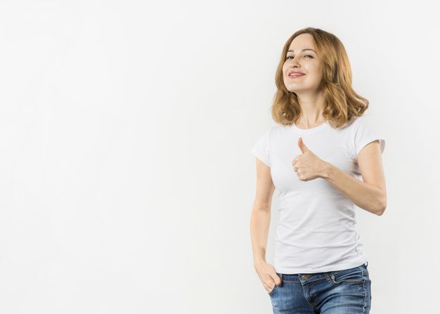 a woman in white shirt standing with her hand on her hip and giving the thumbs up