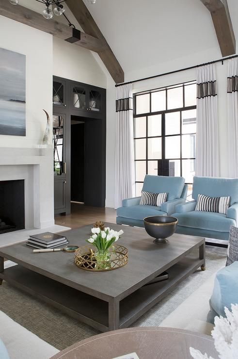 Powder Blue Accent Chairs Topped With Black Striped Pillows Sit On A Gray Rug Facing