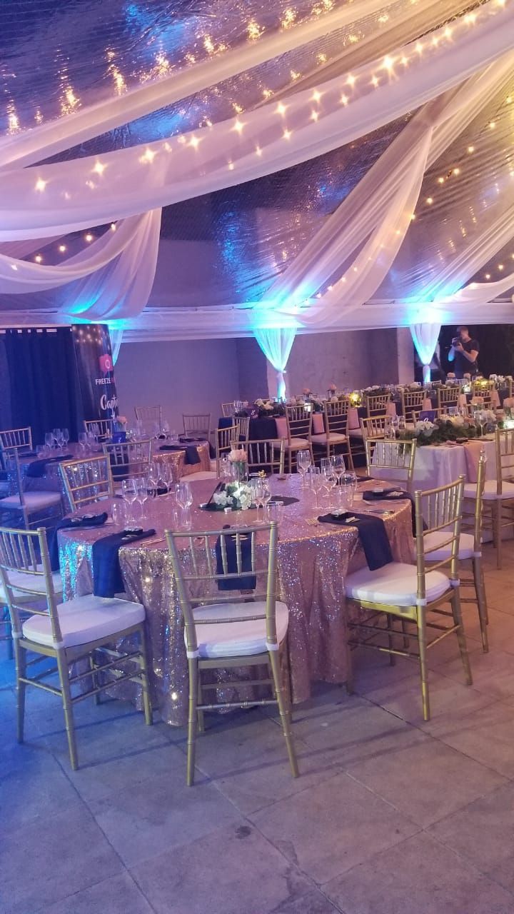 A Banquet Room Set Up For A Formal Event With White Linens And Blue Lights a-banquet-room-set-up-for-a-formal-event-with-white-linens-and-blue-lights