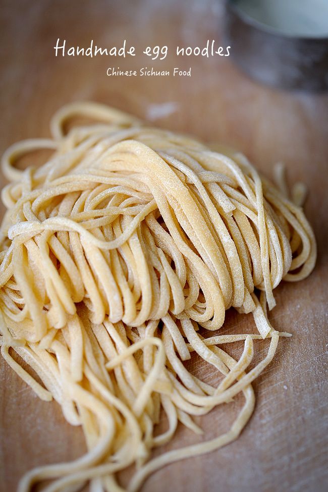 a pile of noodles sitting on top of a wooden cutting board