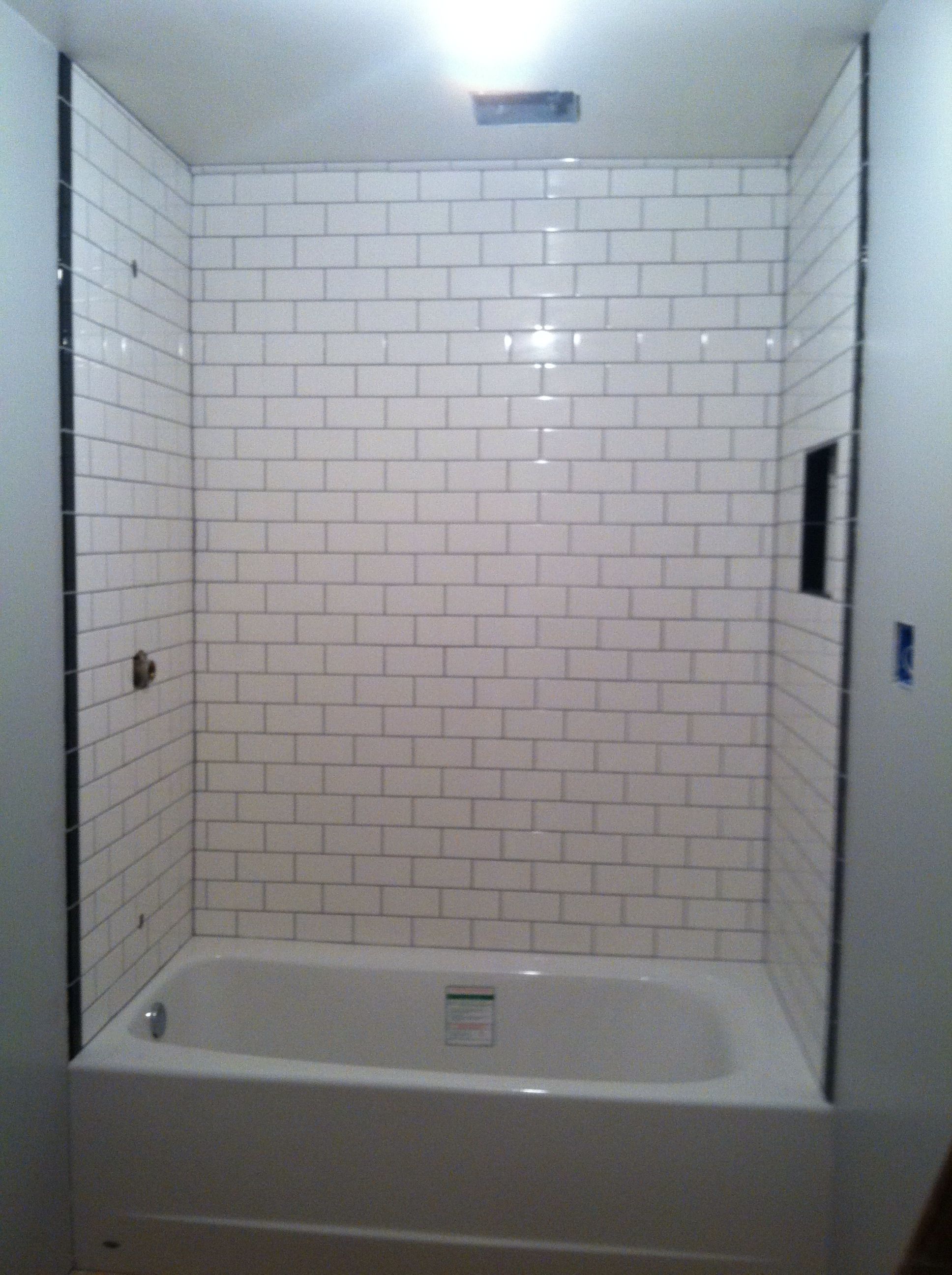 White subway tiles with durbin gray grout. Very timeless look. | White