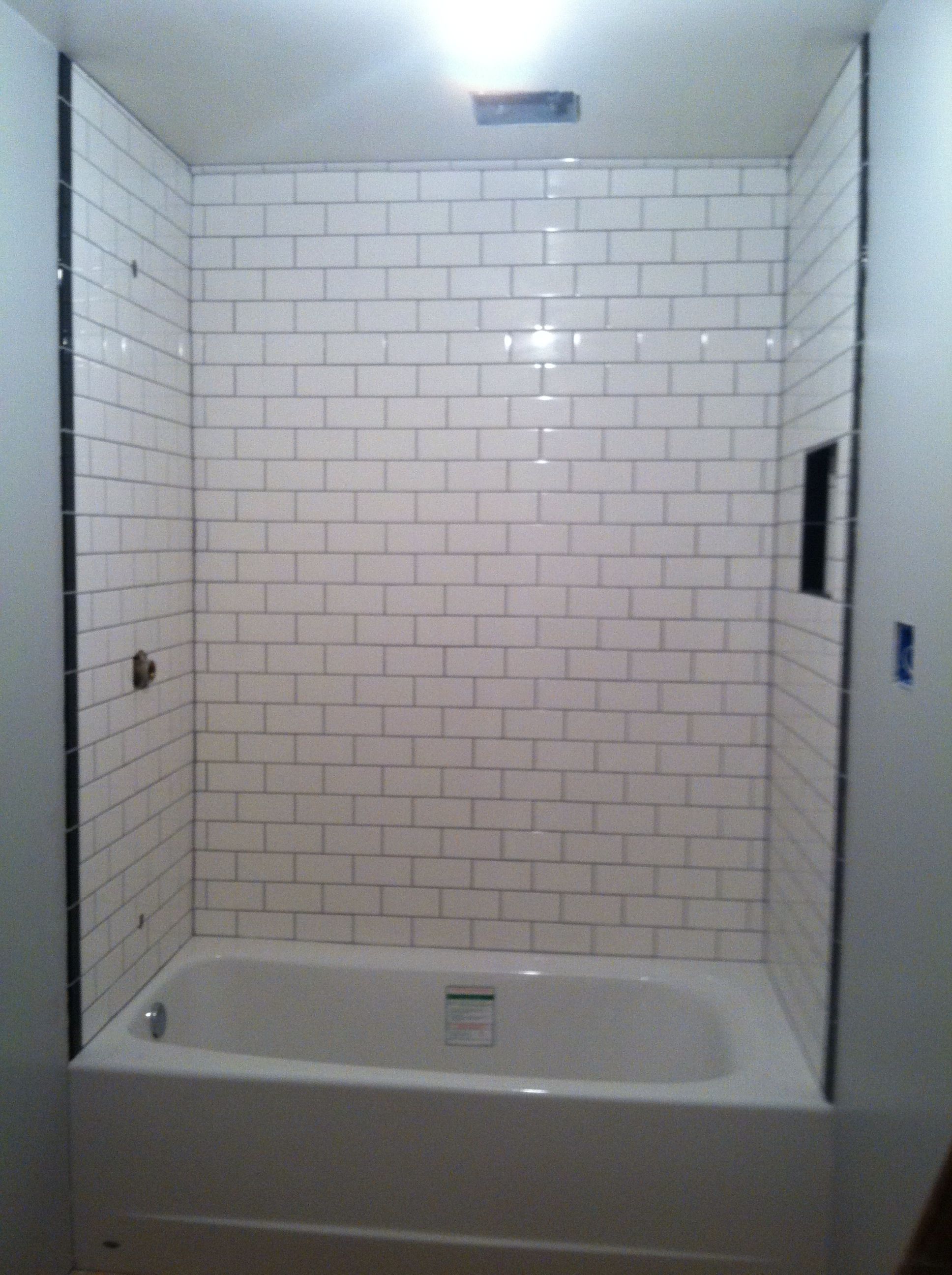 White subway tiles with durbin gray grout. Very timeless look. White