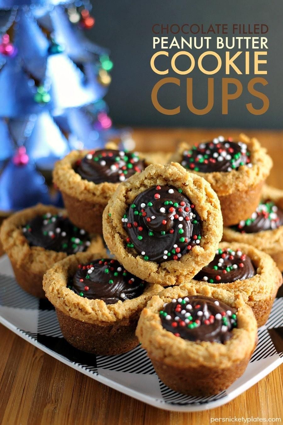 These semi-homemade Peanut Butter Cookie Cups filled with chocolate and topped with sprinkles are a definite crowd-pleaser and are perfect as a last minute holiday dessert addition. | Persnickety Plates AD Best Christmas Recipes, Christmas Recipes Appetizers, Holiday Desserts, Holiday Baking, Fun Desserts, Christmas Food, Delicious Desserts, Christmas Cookies, Dessert Recipes