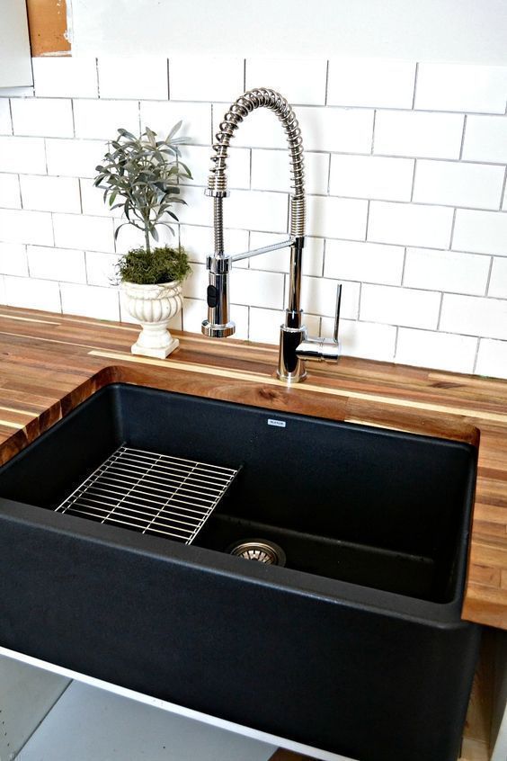 A black farmhouse sink gives our country kitchen a warm feel, #Black #Country #Farmhouse #fe...
