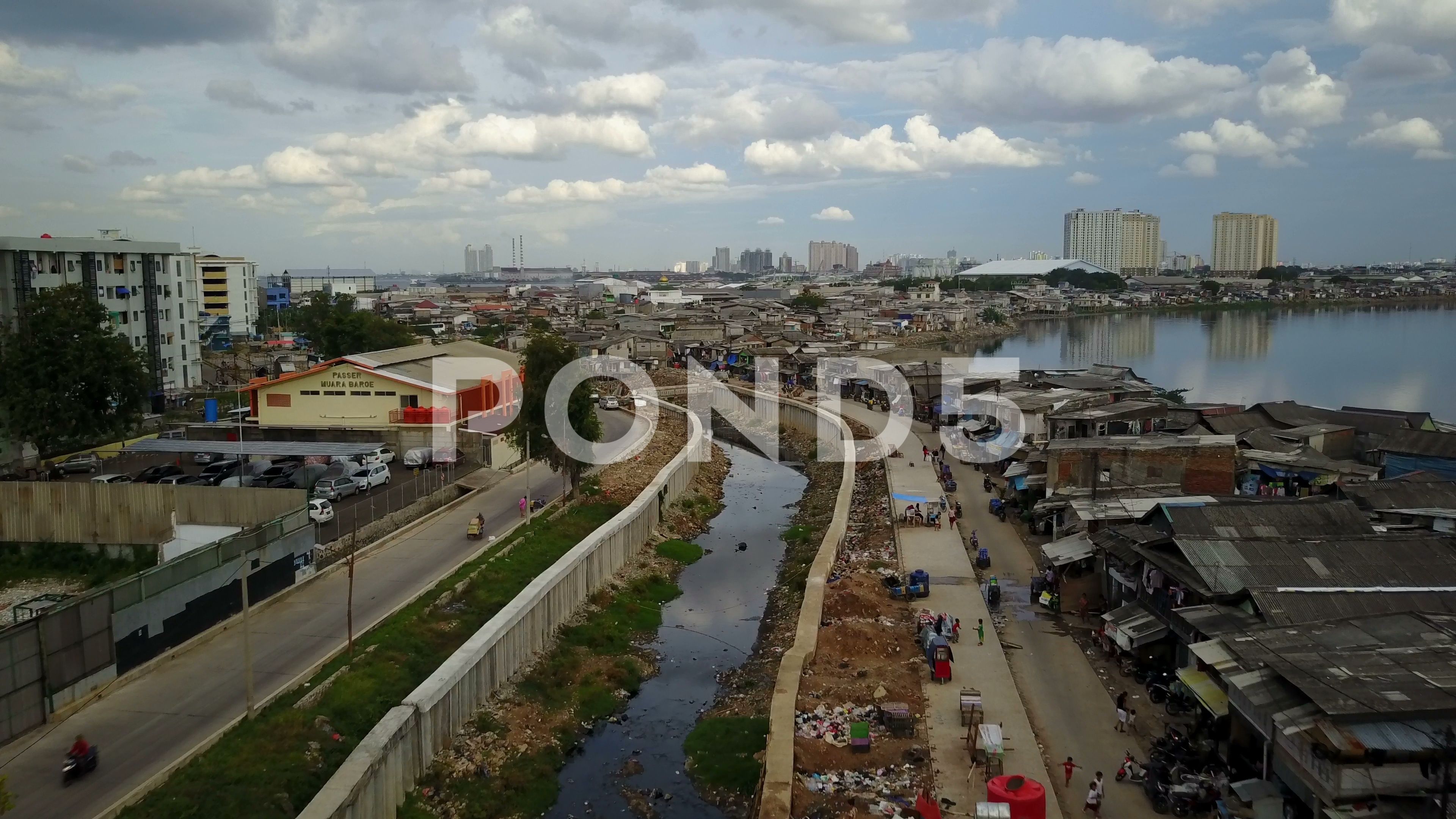 Drone shot of new polluted canal in slum area Jakarta