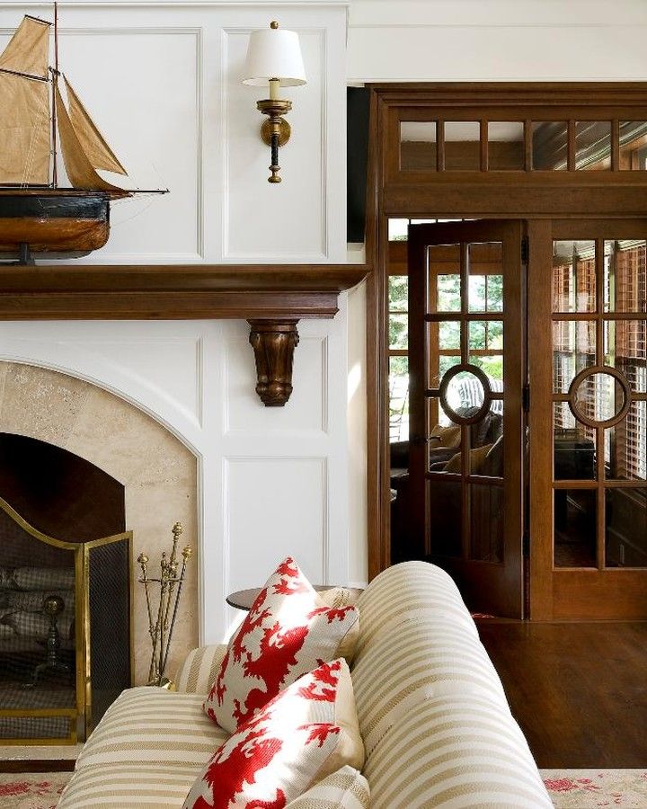 Brass fixtures, circular window details, and a handsome antique give this New England living room a dreamy, nautical touch. 📷: @RobKarosisPhoto . . . . . #architecture #homedesign #newengland #architexture #design #architecturelovers #homestyle #luxuryhome #archdaily #interiordesign #interiorstyle #interiorlovers #interiordecorating #interiorstyling #interiordesire #interiordesignideas #interiordetails #interiorandhome #interiorforinspo #deco #interior #homestyle #archidaily #homedecor #archilo Coastal Living Rooms, Coastal Cottage, Home Living Room, Living Spaces, Interior And Exterior, House Interior, Interior Design, Interior Doors, Traditional Fireplace Mantel