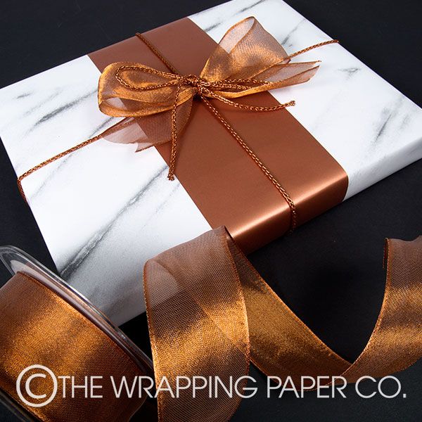 Wrapco Marble gift wrap with a Copper belliband and tied with metallic