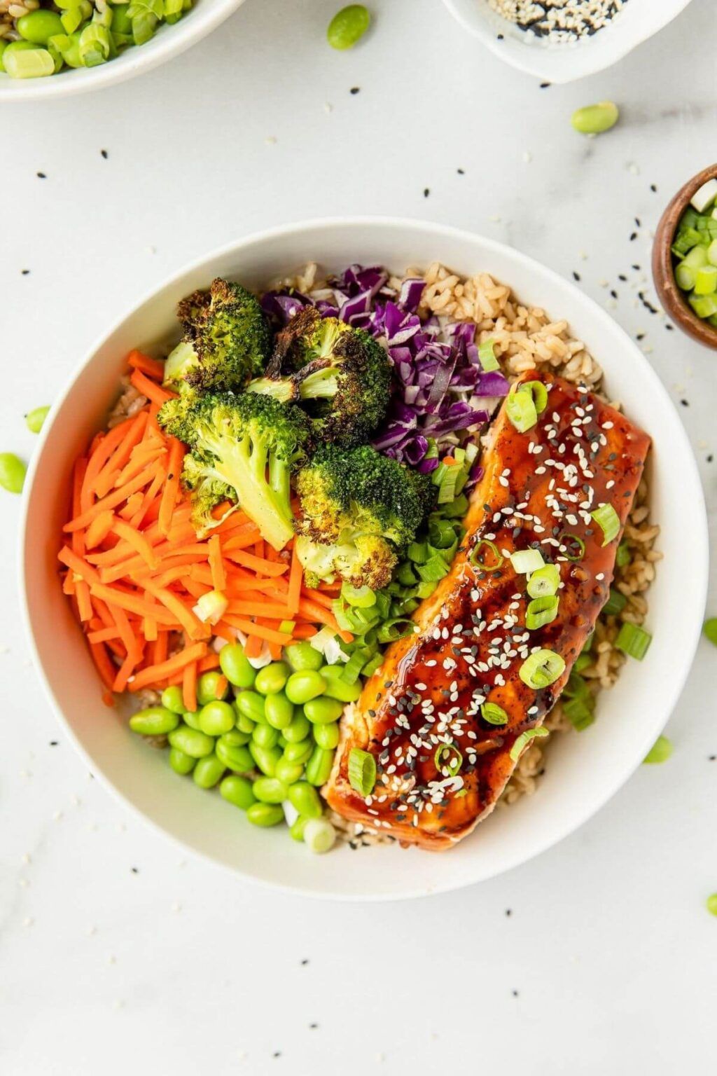 Quick and easy sheet pan teriyaki salmon buddha bowl recipe. These cooked salmon poke bowls are coated in a homemade, sugar free teriyaki sauce and served with crispy roasted broccoli, edamame, and brown rice. A better than take out recipe that is sure to be your favorite dinner! Sugar Free Teriyaki Sauce, Homemade Teriyaki Sauce, Salmon Poke, Buddha Bowls Recipe, Gluten Free Soy Sauce, Salmon Seasoning, Teriyaki Salmon, Poke Bowl, Cooking Salmon