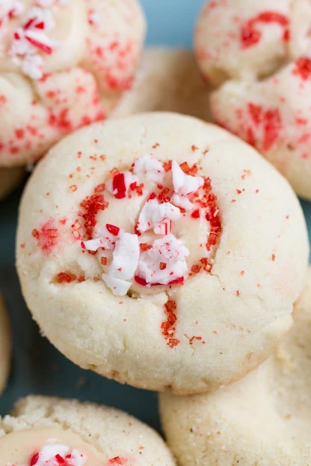 Classic Shortbread Thumbprint Cookies - an easy 5 ingredient dough to make 7 different Christmas cookies including raspberry, apricot and strawberry jam filling, Hershey's Kisses, Nutella and white chocolate with crushed peppermint candy canes! Best of all there's NO spreading or CHILLING required! Perfect for your holiday cookie platter! Christmas Cookies Gift, Easy Christmas Cookie Recipes, Easy Cookie Recipes, Snack Recipes, Christmas Treats, Christmas Foods, Easter Recipes, Shrimp Recipes, Bread Recipes