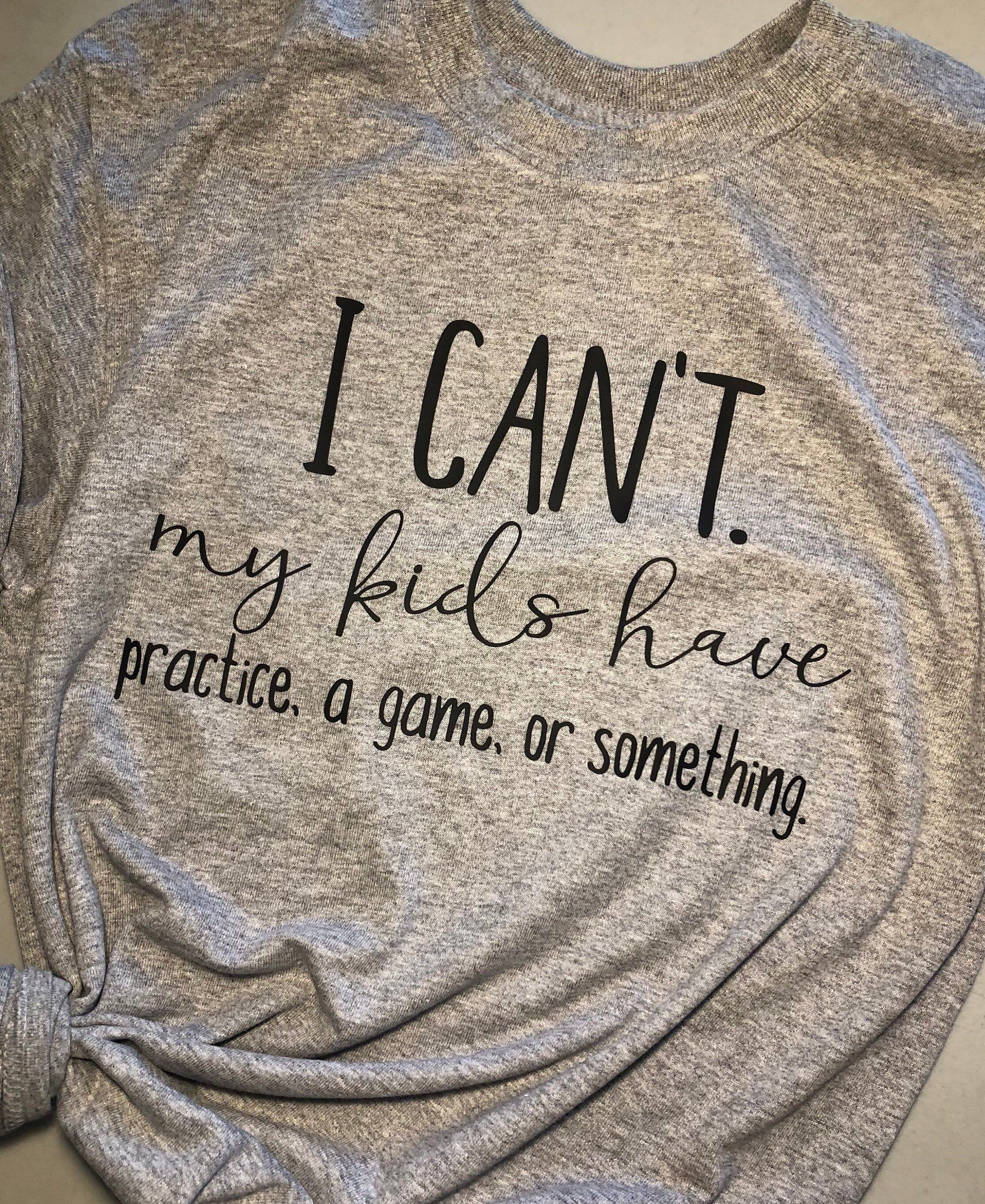 "Sports Mom - I Can't My Kids Have Practice - Funny Mom Shirt - Game Day Shirt - Football Mom Shirt - Soccer Mom Shirt - Mom Life - Baseball Description: I CAN'T. My kids have practice, a game, or something. ️ *note this can be changed to singular* \"MY KID HAS\" Super Cute and Funny Tshirt for any SPORT PARENT out there! Soccer, Baseball, Football.. Moms know the struggle! Unisex cut: soft 50% cotton, 50% polyester blend short sleeve graphite gray t-shirt (contact me if there are other colors d Cheer Shirts, Sports Mom Shirts, Football Mom Shirts, Vinyl Shirts, Funny Shirts, Sports Mom Quotes, Football Moms, Mom Tees, Soccer Mom Shirt