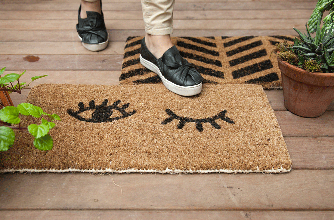 A Person Standing On Top Of A Door Mat a-person-standing-on-top-of-a-door-mat