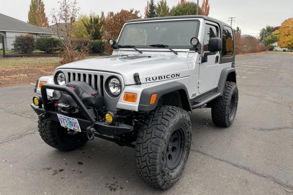 This 2003 Jeep Wrangler Rubicon has remained registered in Oregon since new and was modified following the seller's 2020 acquisition. The truck is powered by a 4.0-liter inline-six mated to a five-speed manual transmission, a dual-range transfer case, and locking front and rear differentials. Modifications include Yukon 4.88:1 gears, a BBK 62mm throttle body, a Magnaflow muffler, aftermarket bumpers, a Warn winch, 16" Pro Comp wheels, a Rubicon Express 3.5" long-arm suspension lift, a Steinjager 2003 Jeep Wrangler, Pro Comp, Rear Differential, Transfer Case, Yukon, Manual Transmission, Muffler, Modified, Bumpers