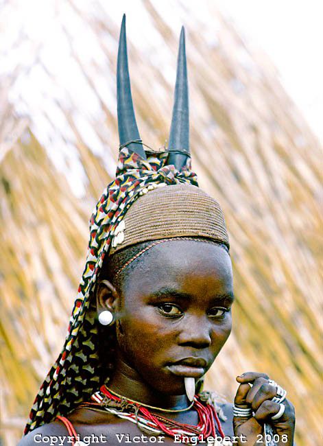 Africa Somba Initiate With Antelope Horns On Her Straw Woven Cap