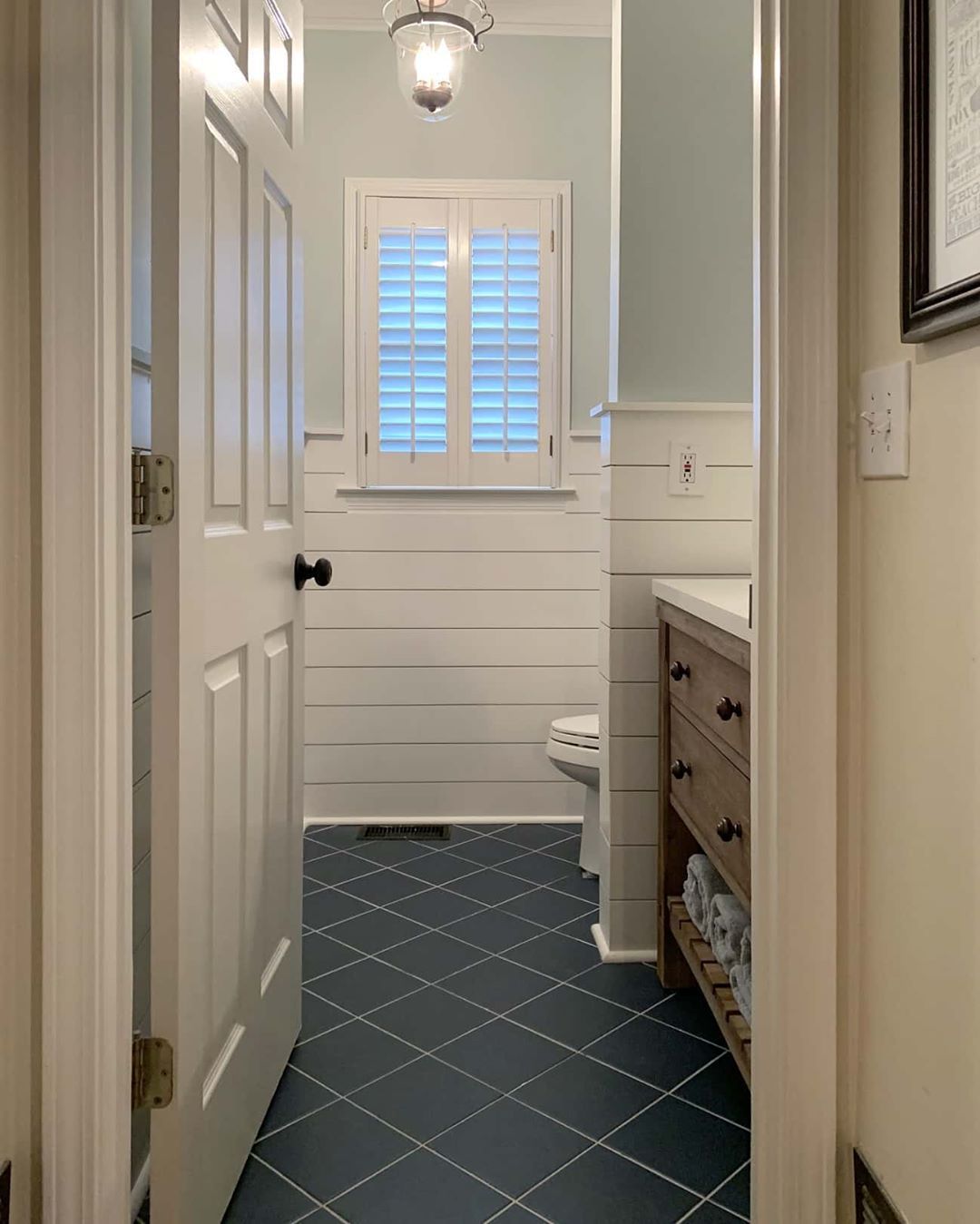 Half bathroom renovation with shiplap wall, blue tile and wood vanity