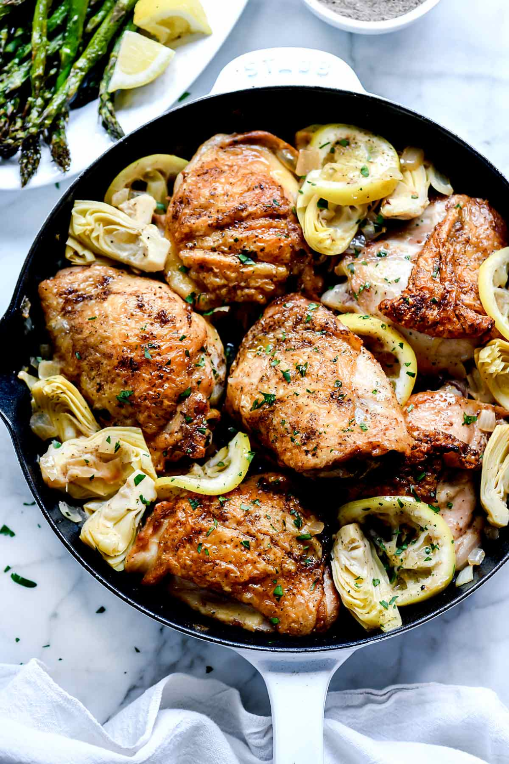 This lemon chicken dinner makes juicy, bone-in chicken thighs in a white wine sauce with artichokes for an easy chicken dinner that's ready in 30 minutes. Lemon Chicken Thighs, Cooking Chicken Thighs, Chicken Thigh Recipes Crockpot, Roasted Chicken Thighs, Lemon Chicken Recipe, Easy Chicken Dinners, Baked Chicken Recipes, Healthy Chicken, Oven Chicken