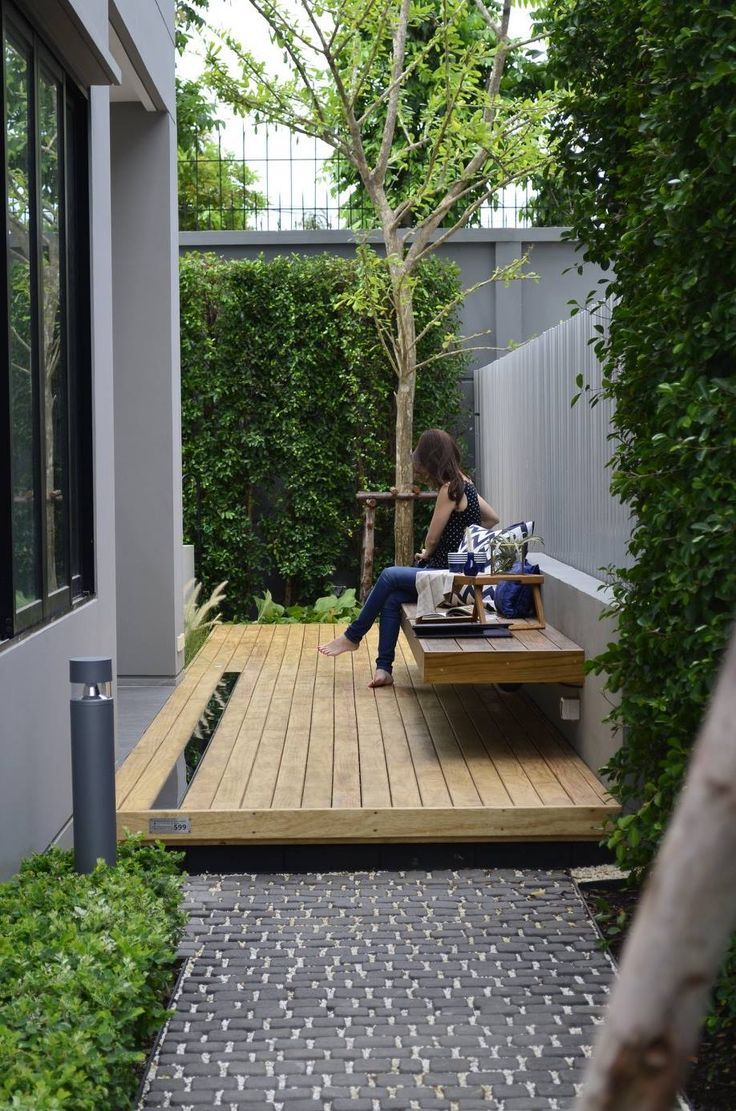 Varying textures, grey tones and timber create a lovely outdoor area. #sideporch
