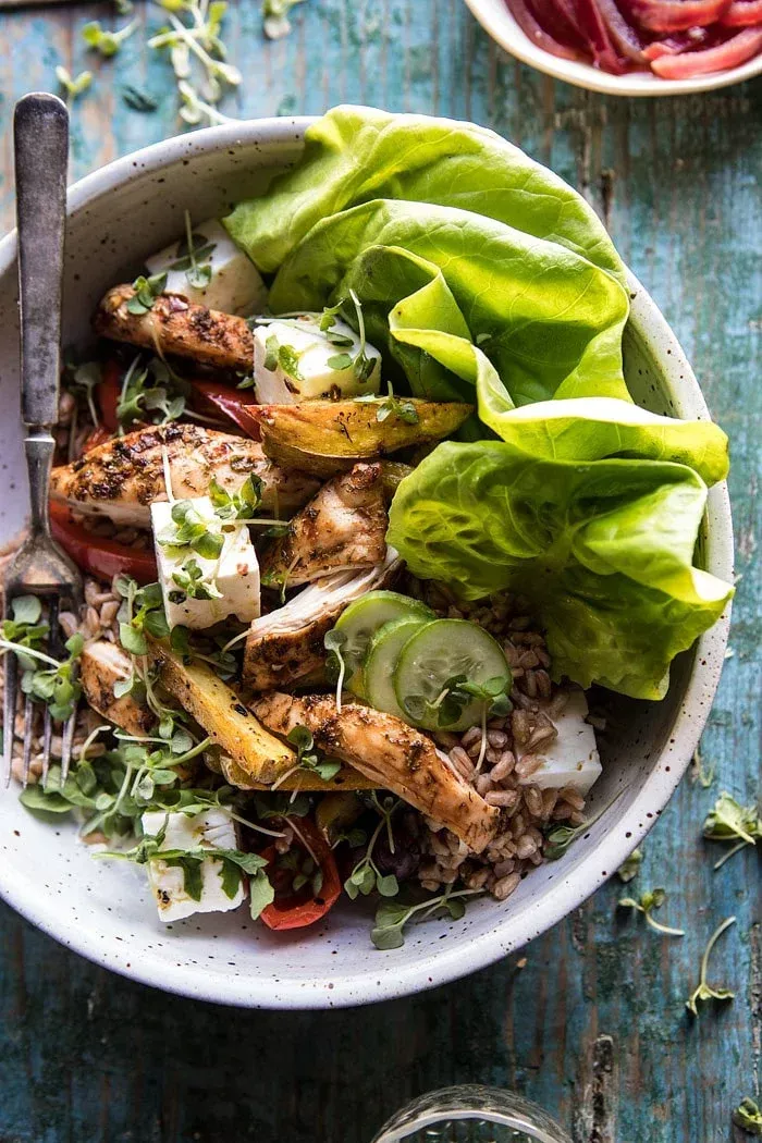 Roasted Greek Chicken and Farro Salad with Oven Fries: packed with whole grains, roasted chicken, veggies, homemade tzatziki, feta cheese, and finished with a simple red wine vinaigrette. There is nothing boring about it! @halfbakedharvest.com
