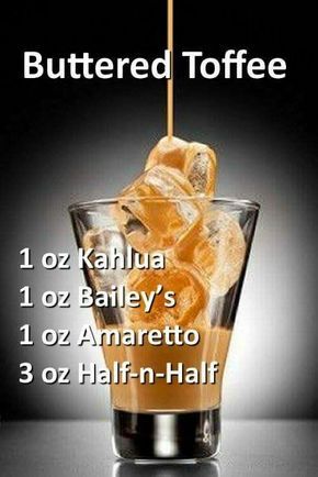Irish creme liqueur pouring into a glass full of i Irish creme liqueur pouring into a glass full of i