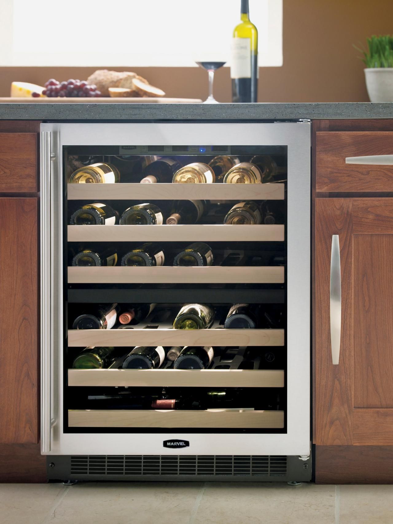 This wine cooler is built into the kitchen cabinets and gives space