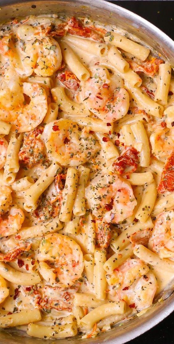 Creamy Shrimp Pasta features creamy Mozzarella sauce, sun-dried tomatoes, basil, and red pepper flakes. Easy weeknight dinner