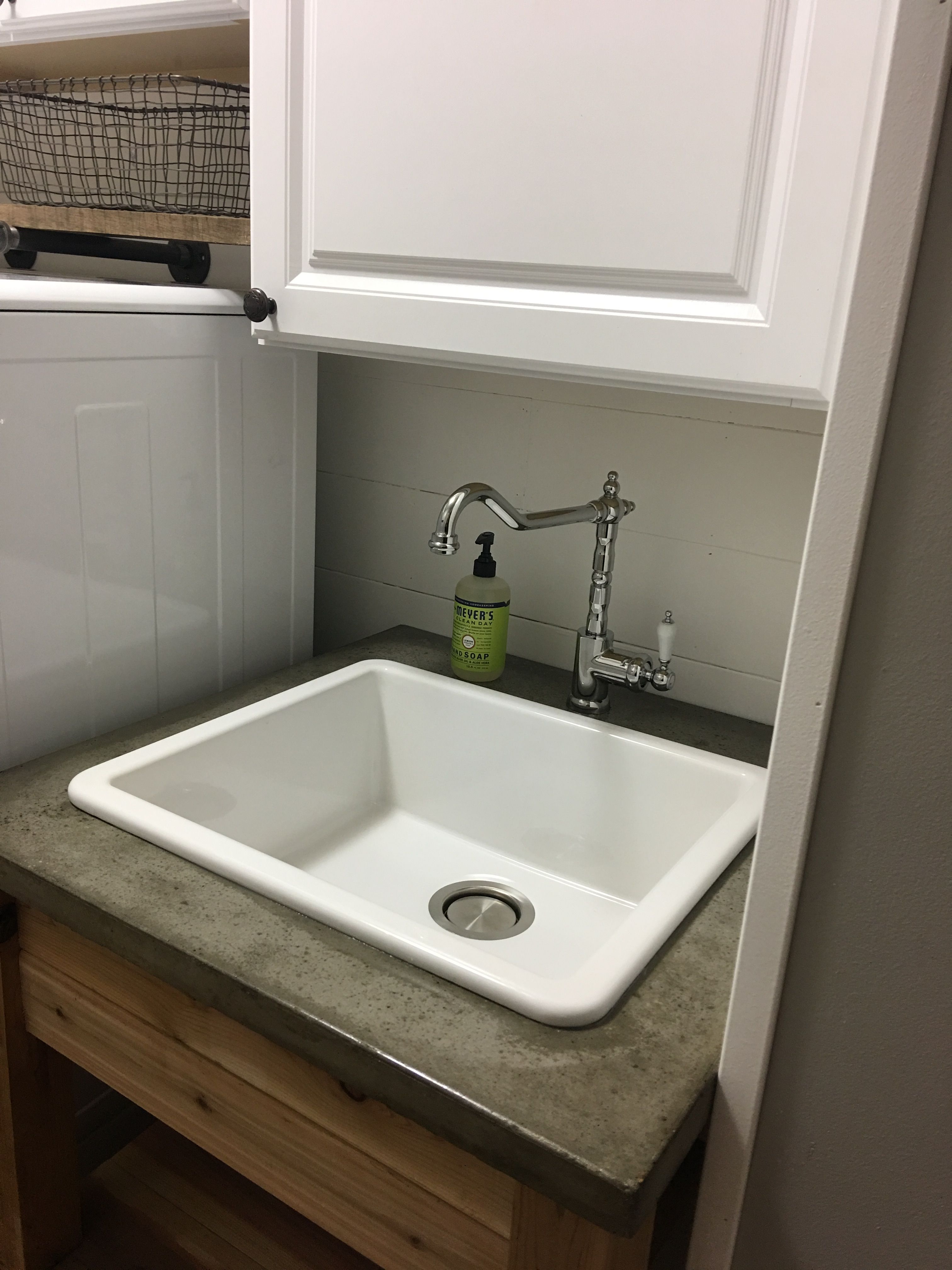 Laundry room sink with concrete top.