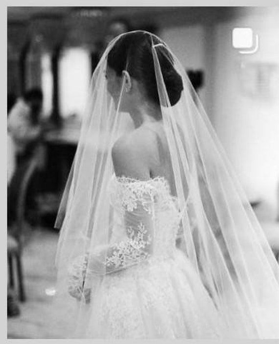 "Make a statement in our Jennifer Cathedral Drop Wedding Veil, a beautifully soft, sheer illusion tulle veil, available in Cathedral, Royal or Regal length, as well as custom length blusher. *The DROP veil is FLAT at crown of head, no fullness. Soft oval cut veil, drapes over the head. *Comb is Not Sewn on to veil, as multiple threads required, stress tulle during movement. *Jennifer is SECURED with a SEPARATE ribbon wrapped wire comb and Crystal Hat Pin. * HOW-TO-SECURE- DROP-VEIL instructions Monique Lhuillier, Cathedral Bridal Veils, Cathedral Veil Hairstyle, Cathedral Length Wedding Veil, Crystal Veil Cathedral, Drop Wedding Veils, Wedding Crown Veil, Long Veils Bridal, Veil Over Face