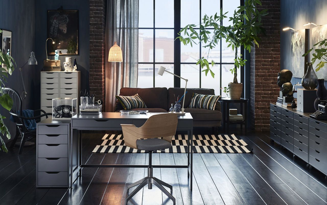 A grey desk in the middle of a large home office combined with a Home Office With Desk In Middle Of Room