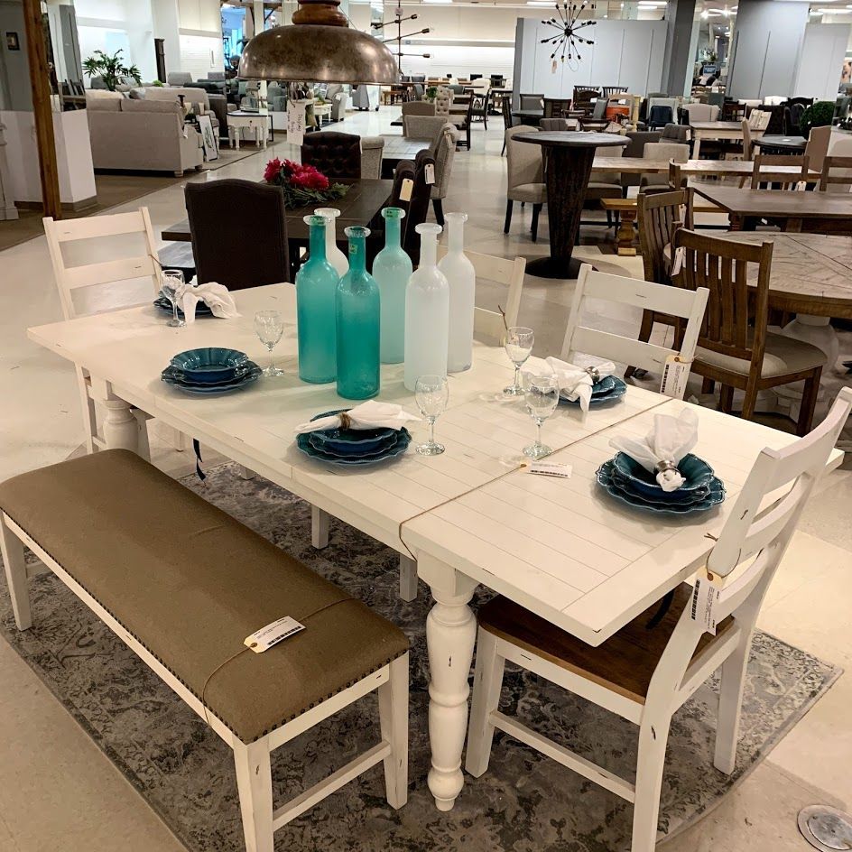 Light Wood Dining Table Surrounded By Sleek Black Chairs Under A White Drum Hanging Light A Light Wood Dining Table Modern Farmhouse Dining Wood Dining Table