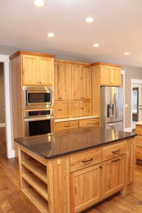 Open shelving on the side of an island adds space for decor AND extra