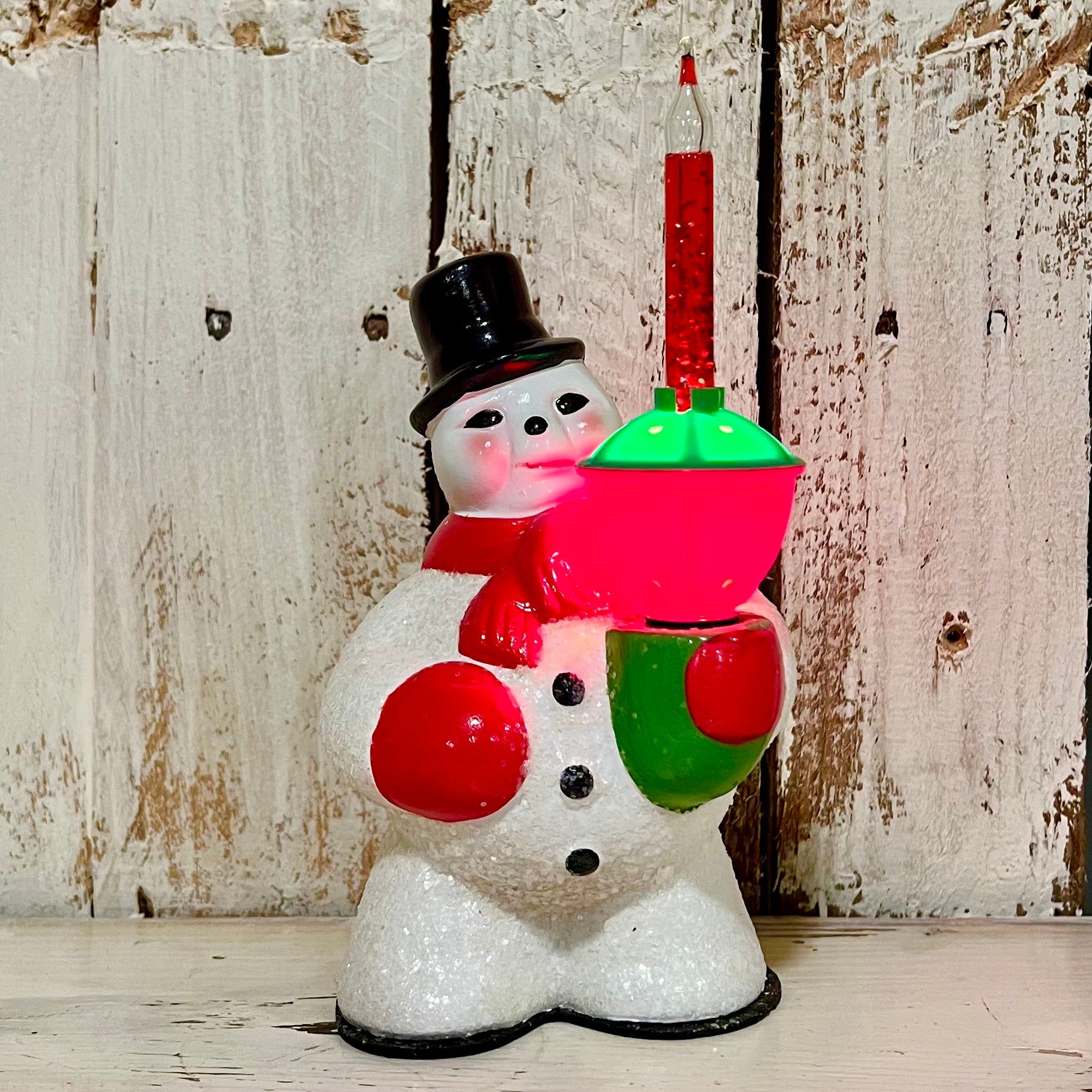 Bring back the nostalgia and memories of holidays gone by with this 1950's vintage-inspired bubble light plugin Snowman. The wow factor for this snowman bubble light is massive! Add some retro vibes to your house this Christmas! Materials: Hand-glazed ceramic, electrically wired glass bubble light, glitter Dimensions: 8.5" X 4.5" Includes light, plugs into US outlets Sold individually Brand: Bethany Lowe Designs, SKU: LG9866 Bubble lights are windows into Christmases past...check out more in the Christmas Candy Cane, Novelty Christmas, Christmas Ornaments, Wired Glass, Bethany Lowe, Retro Vibe, Glazed Ceramic, 1950s Vintage, Wow Products