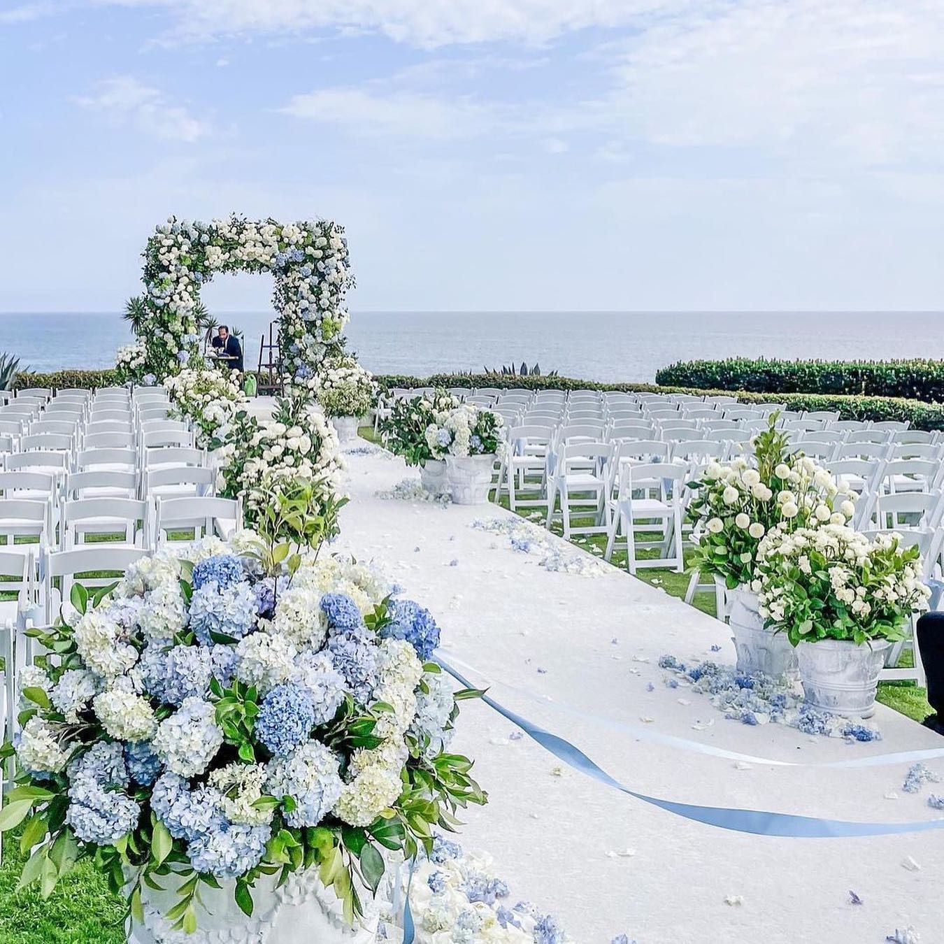 Traditional brides looking for that perfect "something blue" wedding idea, look no further than this beautiful blue and white floral wedding décor. The potted hydrangeas flow into a stunning ceremony arch overlooking the beach skyline at this classic summer wedding. Get more blue wedding flower inspo at the link. // Photo: John and Joseph, Florals: Nancy Kaye of Marks Garden, and Planner: Mindy Weiss Vintage Blue Weddings, Baby Blue Weddings, Beach Wedding White, Blue White Weddings, Summer Wedding, White Wedding Ceremony, Floral Arch Wedding, Wedding Flowers Hydrangea, Arch Flowers