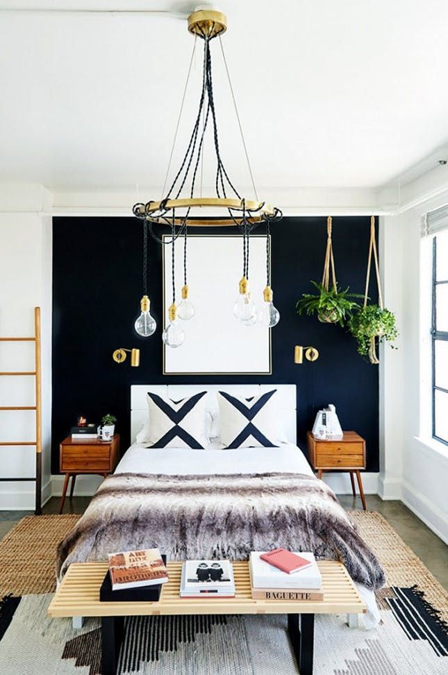 cozy blue black bedroom bedroom. this bold bedroom is all about its high-contrast black and white palette, warmed up by wood, jute brass. be fearless with graphics\u2014and wall cozy blue