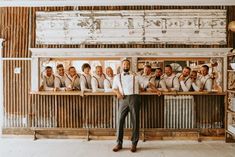 Groomsmen styled in vintage-inspired fashion with brown suspenders dried flower...