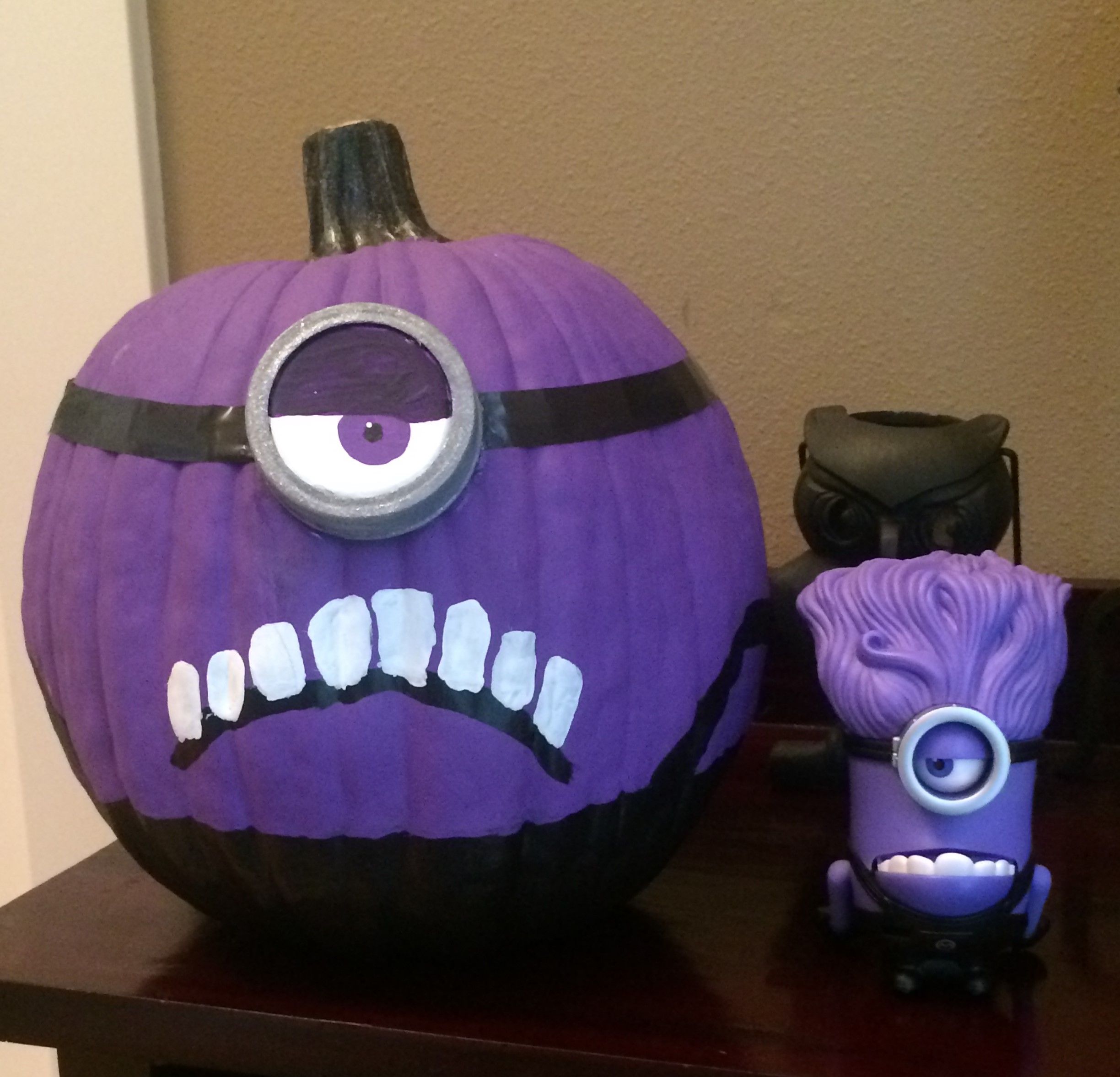 Purple evil minion...1 fake pumpkin, purple, black and white paint ...