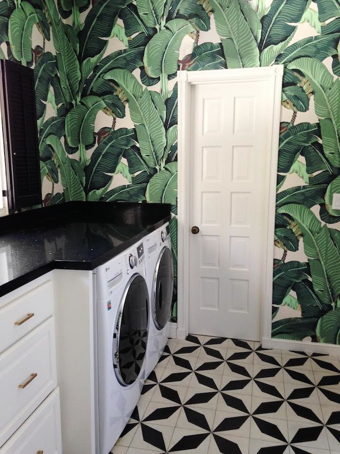 Bold black and white laundry room with tropical wall