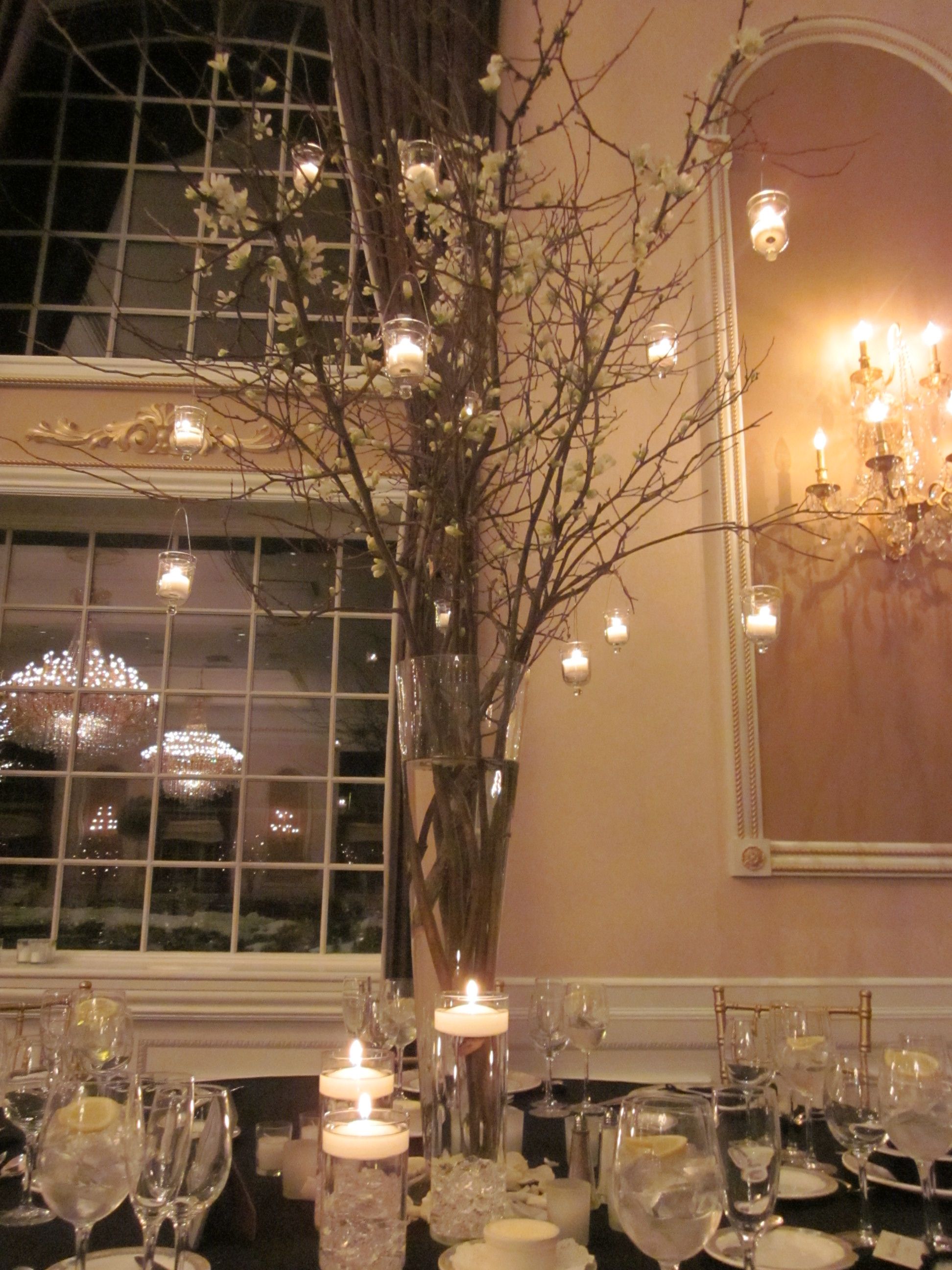 Tall Centerpiece With White Dogwood Branches And Hanging Votive Candles Tall Centerpiece With White Dogwood Branches And Hanging Votive Candles
