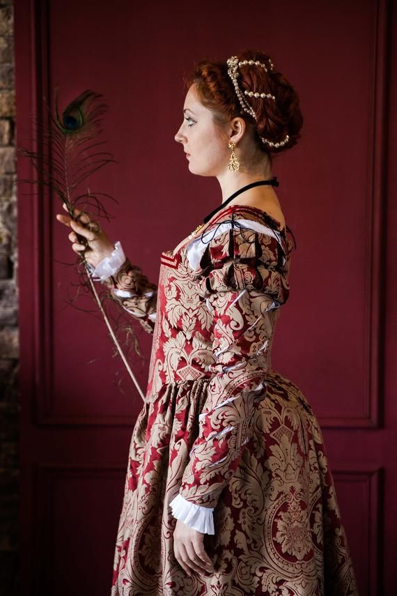 Luxurious red and beige-gold 1550s gown will be a true sensation on Renaissance ball or festival.The dress bodice is boned and works like a corset. Fashionable slashed sleeves are worn separately and are to be laced up according to 1500s female fashion.The chemise and other undergarnments (like bumroll or petticoat) are to be purchased separately according to your needs.This was one of a kind gown, but the same designs are available in other fabrics and colours. The dress can be made after your Renaissance Wedding Dresses, Italian Renaissance Dress, Renaissance Clothing, Renaissance Fair, 1500s Dress, Midevil Dress, Ukraine, Historical Hairstyles, 18th Century Costume