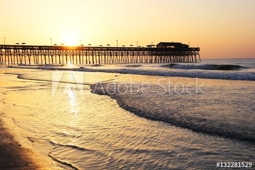 Golden sunrise over Atlantic ocean. Atlantic Ocean view with a pier in Myrtle Beach area, South