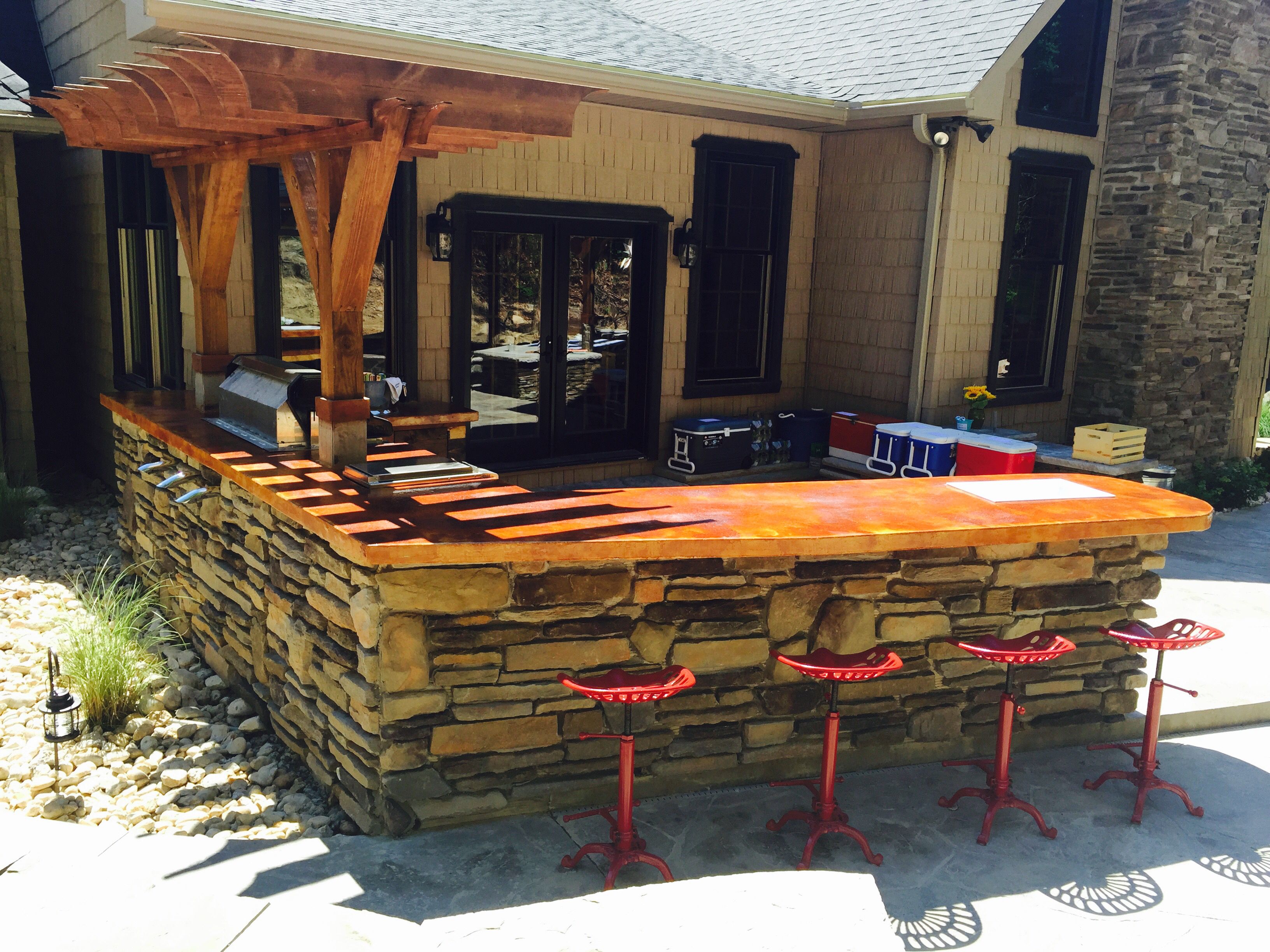 Outdoor bar area, stone on outside, concrete and stained countertops