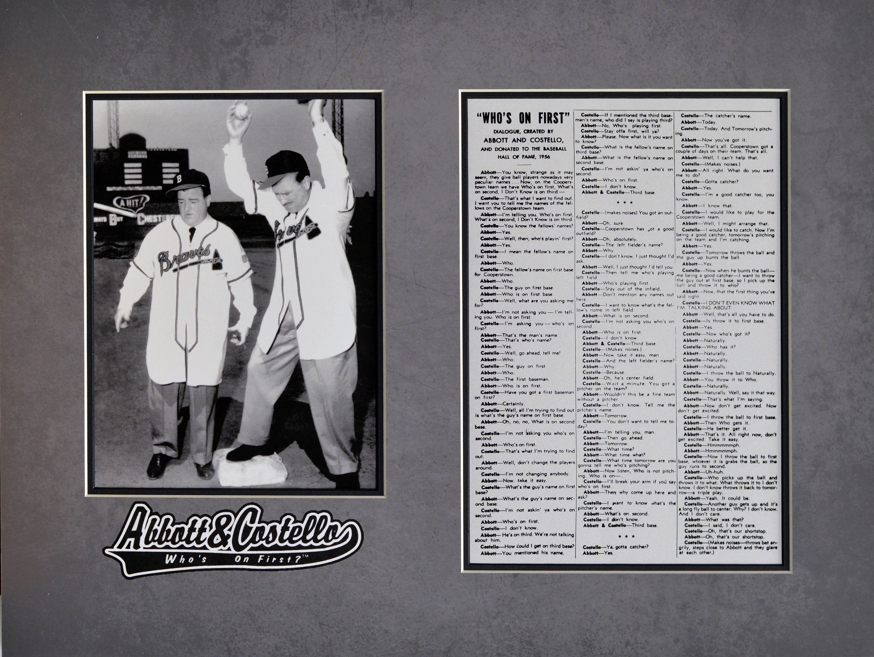 Two men standing next to each other in front of a poster