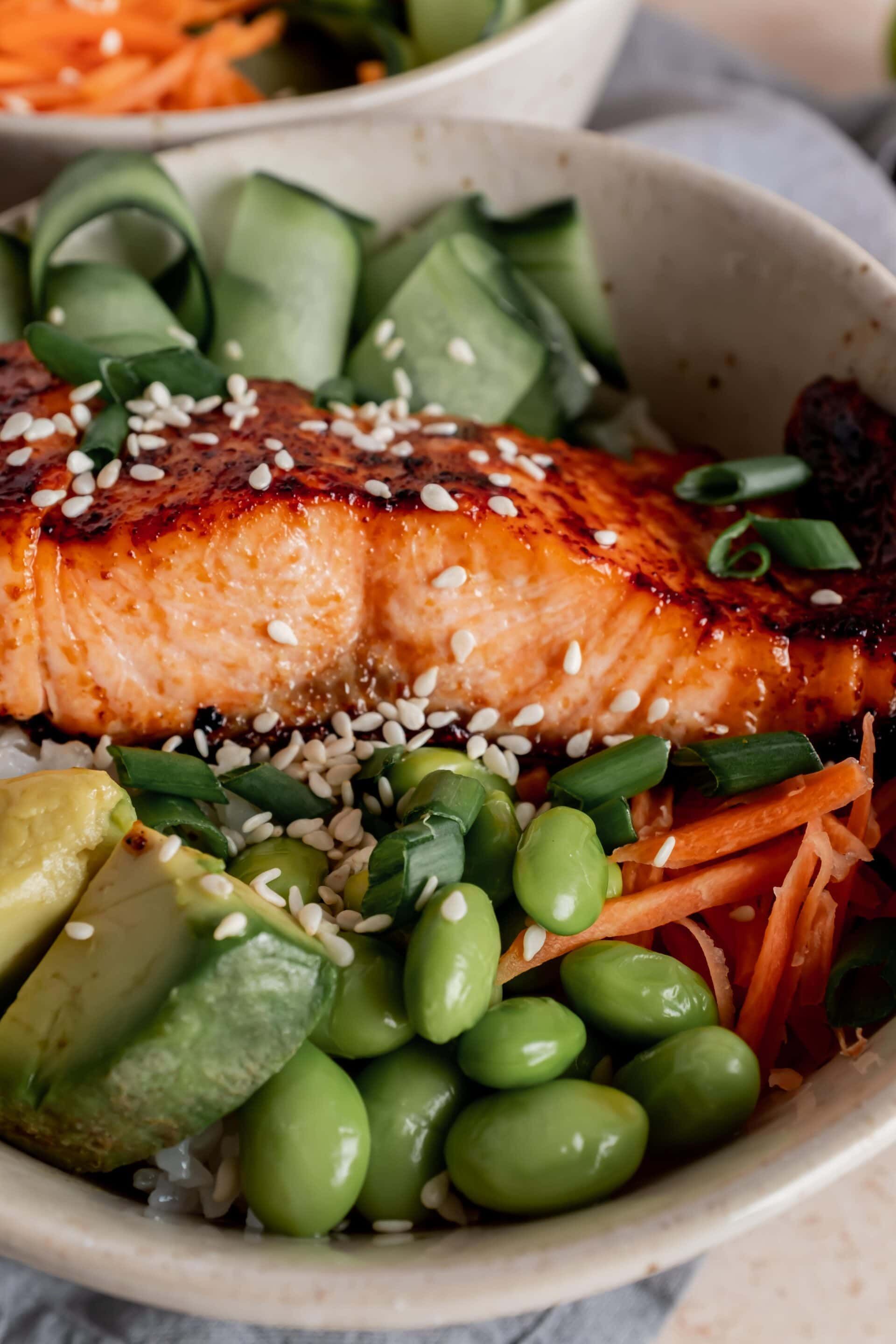 Made with deliciously seasoned sushi rice and salmon that is broiled to perfection in just minutes, these salmon rice bowls are both hearty and healthy! Add your favorite veggies, drizzle with a bit of soy sauce and enjoy!
