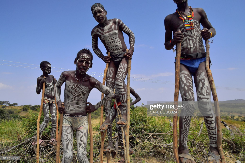 Young Boys From The Mursi Tribe Walk On Stilts In Ethiopia s Southern young-boys-from-the-mursi-tribe-walk-on-stilts-in-ethiopia-s-southern