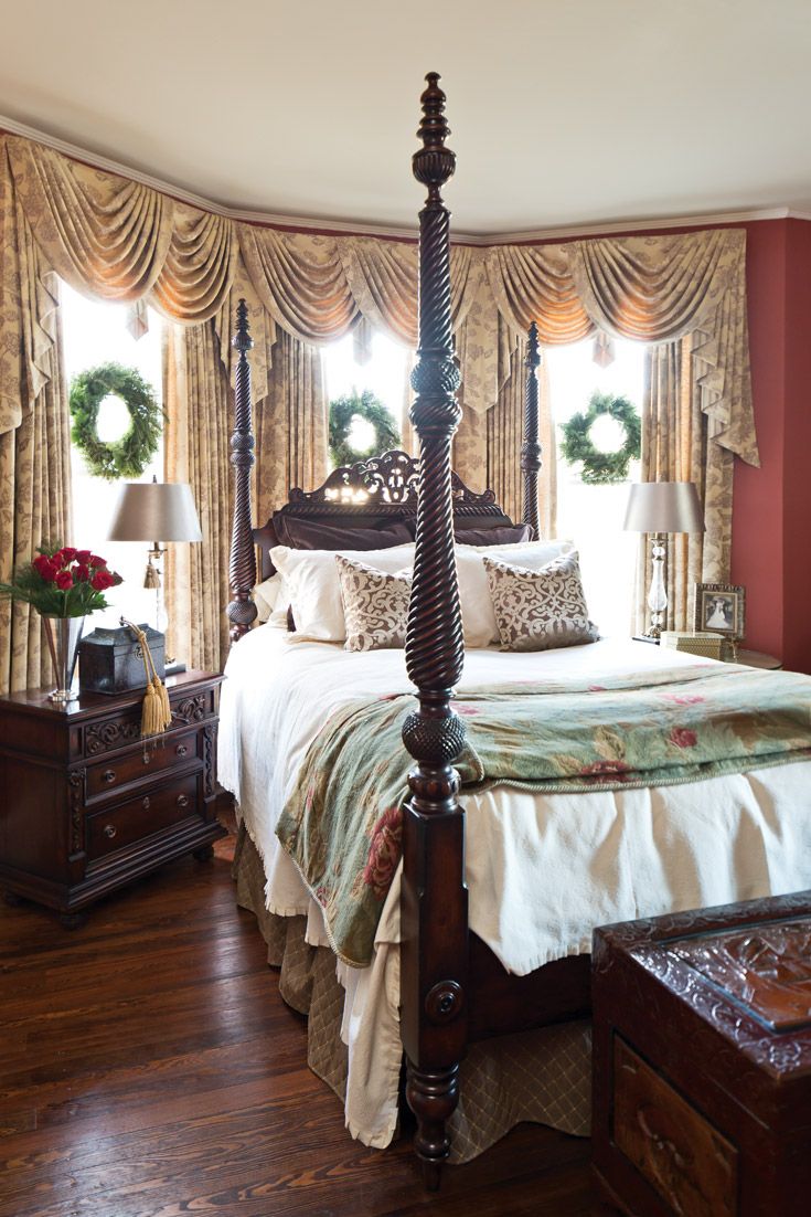 Wreaths at the windows, a vase of red roses, and gold tassels tied to a Wreaths at the windows, a vase of red roses, and gold tassels tied to a