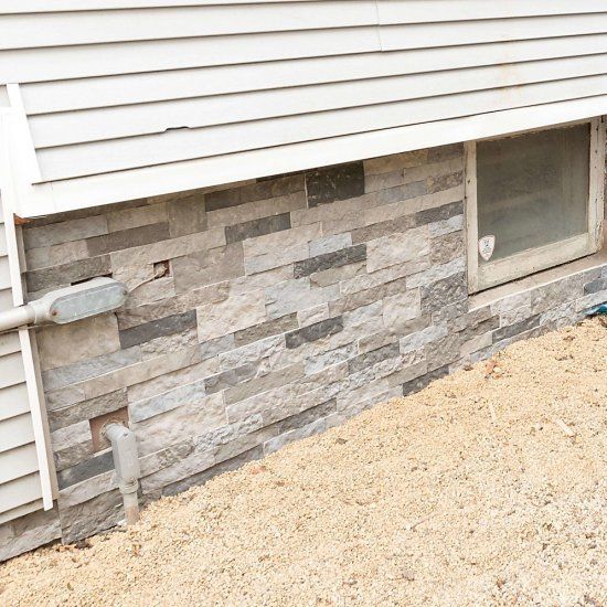 Update your foundation wall with a faux stone veneer for a simple DIY