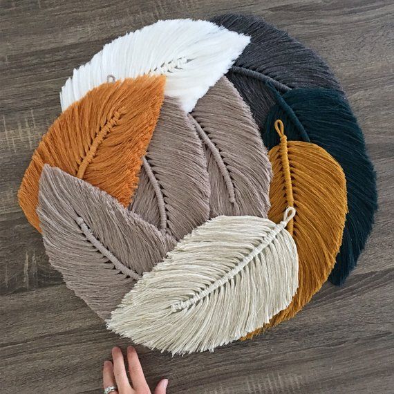 A handmade bohemian inspired feather (or leaf) macramé wall charm knotted from super soft luxe 100% natural cotton. Includes loop at the end for hanging and felt backing. Scoops slightly to the left. Measurements- approx. 17cm width by 35cm length. These will be posted via untracked