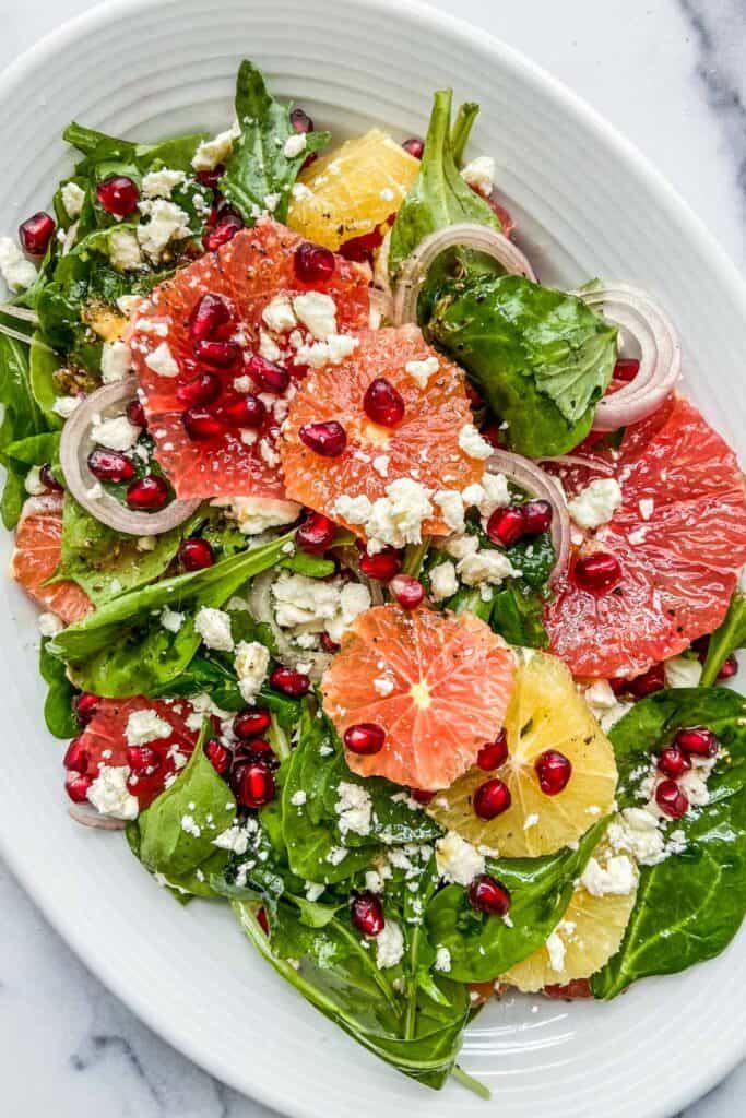 This beautiful pomegranate citrus salad is a bright and refreshing dish. It's a celebration of winter fruit on a bed of delicious greens, served with some crumbly feta cheese. Citrus Fruit Salad, Citrus Salad Recipes, Winter Salad Recipes, Pomegranate Salad, Vegetarian Salad Recipes, Yummy Salad Recipes, Delicious Salads, Eating Light, Salads