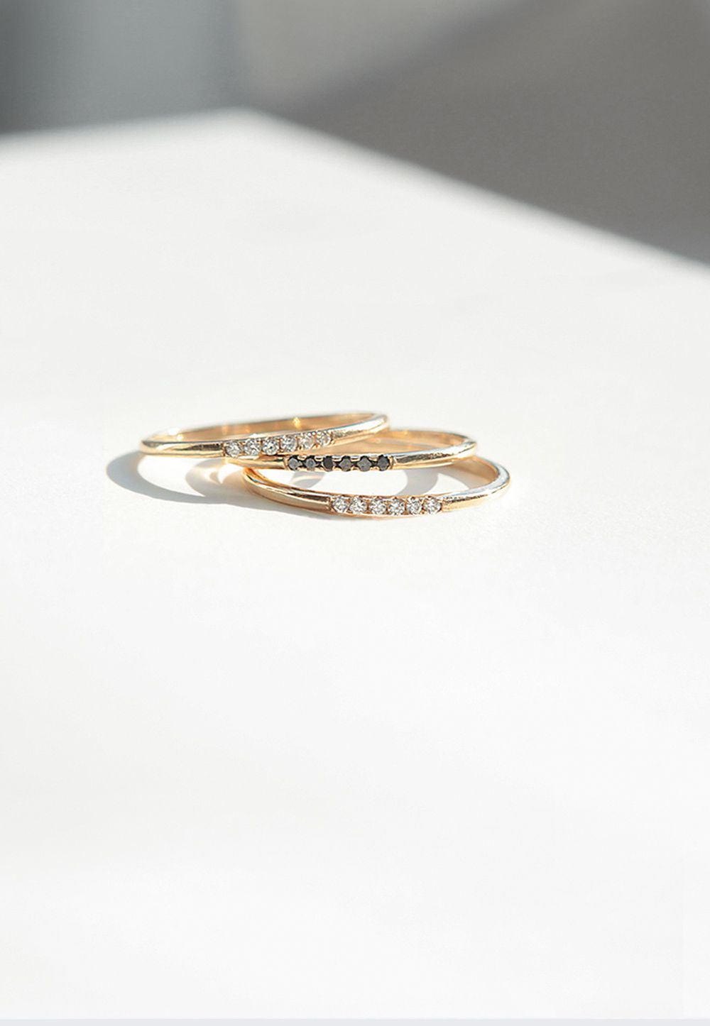 Fine stackable rings by Mejuri in 14k solid gold with diamonds and